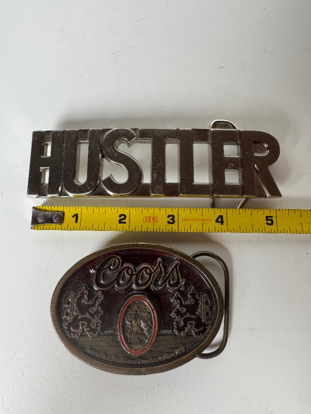Vintage Belt Buckle Lot of 2 Hustler Chrome Logo and Coors Beer Brass